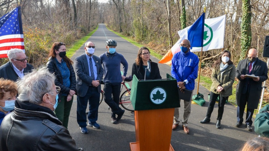 The Parks Dept. has completed a $1.85 million revamp of a section of the Vanderbilt Motor Parkway in Oakland Gardens. Pictured are attendees at a ceremonial ribbon-cutting event Friday (NYC Parks/ Daniel Avila)