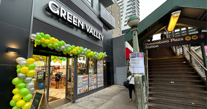 [caption id="attachment_34549" align="aligncenter" width="874"] Green Valley in Queens Plaza (Photo by Michael Dorgan)[/caption] Feb. 9, 2023 By Michael Dorgan A new family-operated deli/grocery store has opened on a busy street in the Queens Plaza section of Long Island City. The new store, called Green Valley, opened Monday at 25-12 Queens Plaza S. The store faces the steps to the Queensboro Plaza subway station and is adjacent to a Starbucks coffee shop. It has replaced Yoyoso, a global discount store chain that closed last year. Green Valley is owned by brotehrd . who also owns a deli called Plaza Express Deli, which is located on the next block on the corner of Queens Plaza South and Crescent Street. The store has no affiliation with the Green Valley supermarket on Greenpoint Avenue in Sunnyside.   It will offer a range of quick hot food items, cold sandwiches, salads, smoothies and typical grocery items such as XXX. The store has undergone a complete overhaul with a fresh and bright new look. The floors have been replaced, while new shelves, light fixtures, refrigerators and check-out counters have been installed. A new sign has gone up outside along with green and yellow colored balloons. A new deli area has been built on the right side of the store that offers hot food items, cold sandwiches and salads. Green Valley sells a host of grocery items including dry food options, canned goods, frozen foods, snacks, as well as personal care items. There are no seats inside. Opening hours are from [caption id="attachment_34565" align="aligncenter" width="874"] The store faces the steps to the Queensboro Plaza subway station and is adjacent to a Starbucks coffee shop (Photo by Michael Dorgan)[/caption] [caption id="attachment_34551" align="aligncenter" width="874"] Green Valley in Queens Plaza (Photo by Michael Dorgan)[/caption] [caption id="attachment_34564" align="aligncenter" width="874"] Green Valley in Queens Plaza (Photo by Michael Dorgan)[/caption] [caption id="attachment_34563" align="aligncenter" width="874"] Green Valley in Queens Plaza (Photo by Michael Dorgan)[/caption] [caption id="attachment_34562" align="aligncenter" width="874"] Green Valley in Queens Plaza (Photo by Michael Dorgan)[/caption] [caption id="attachment_34560" align="aligncenter" width="874"] Green Valley in Queens Plaza (Photo by Michael Dorgan)[/caption] [caption id="attachment_34558" align="aligncenter" width="874"] Green Valley in Queens Plaza (Photo by Michael Dorgan)[/caption] [caption id="attachment_34556" align="aligncenter" width="874"] Green Valley in Queens Plaza (Photo by Michael Dorgan)[/caption] [caption id="attachment_34555" align="aligncenter" width="874"] Green Valley in Queens Plaza (Photo by Michael Dorgan)[/caption] [caption id="attachment_34553" align="aligncenter" width="874"] Green Valley in Queens Plaza (Photo by Michael Dorgan)[/caption] [caption id="attachment_34552" align="aligncenter" width="874"] Green Valley in Queens Plaza (Photo by Michael Dorgan)