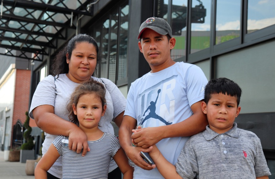 Yohandri Arevalo, pictured second from the right, with his family outside the Collective Paper Factory, a hotel in Long Ialsn City that was recently converted into a shelter (Photo by Michael Dorgan)