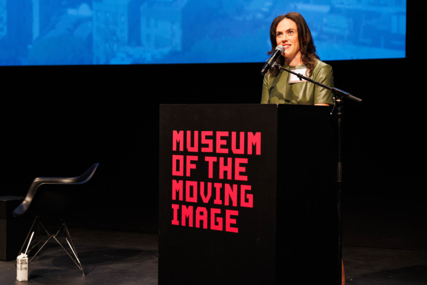 Long Island City Partnership president Laura Rothrock delivers welcoming remarks at a previous LIC Summit event at The Museum of the Moving Image. (Photo by Paul Frangipane)