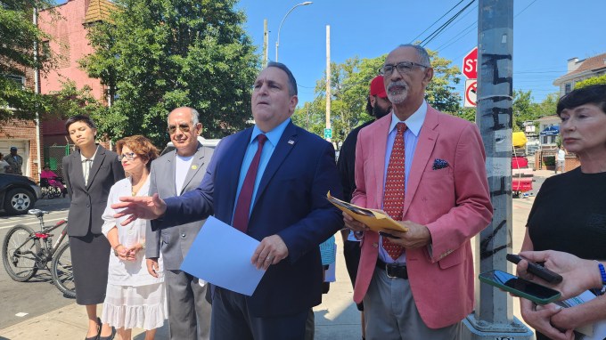 Hiram Monserrate (center right) speaks to the press during Thursday's event near Roosevelt Avenue. Photo: Shane O'Brien