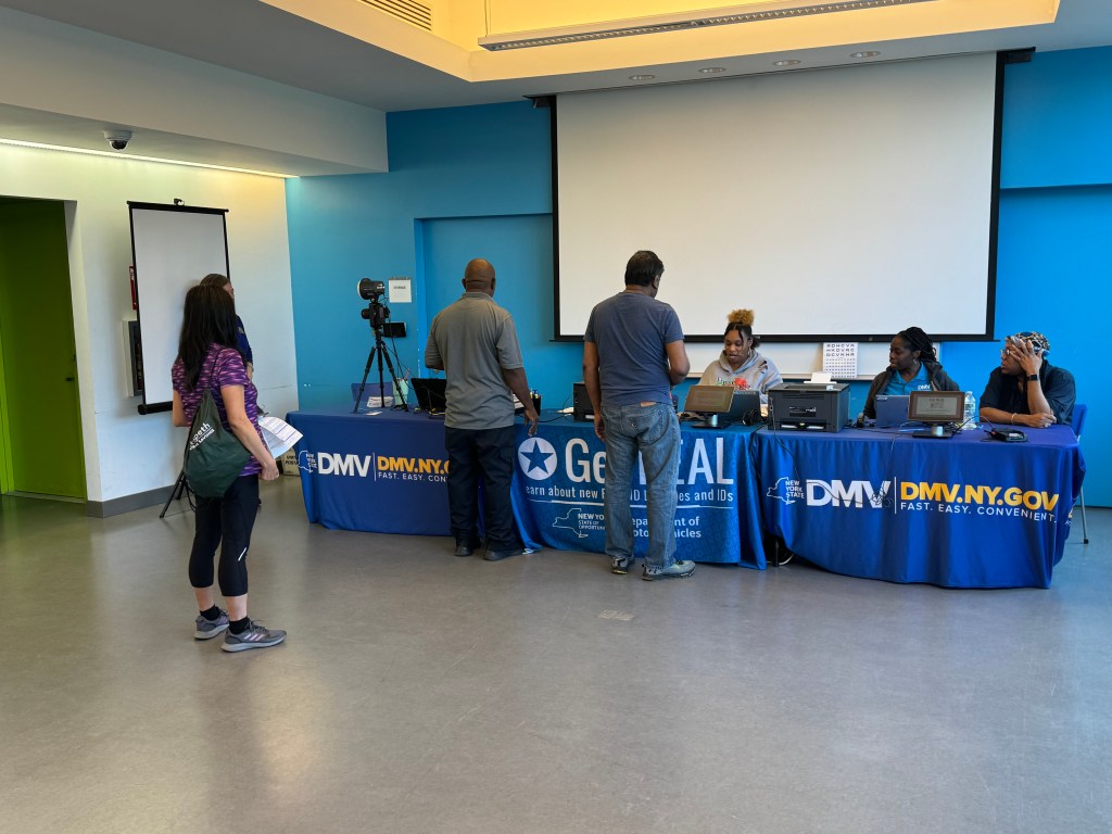 Locals visit the mobile DMV office at QPL Elmhurst to secure their REAL IDs. Photo: Office of State Sen. Mike Gianaris.