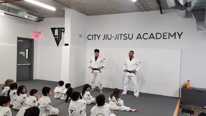 Royce Chen (left) and Daniel Sena Paulino (right) talk to students at the grand opening of City Jiu-Jitsu Academy on Sunday. Photo: Shane O'Brien