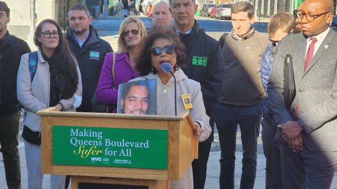 Lizi Rahman holds a photograph of her son Asif during Tuesday's rally. Photo: Shane O'Brien