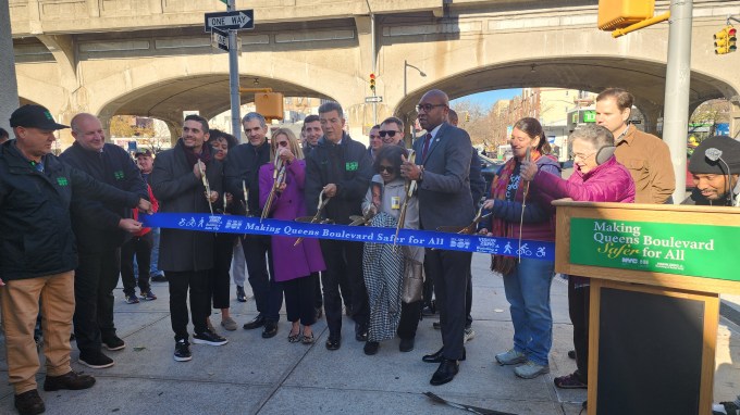 DOT officials, elected officials and transportation advocates cut the ribbon for the Queens Boulevard Redesign. Photo: Shane O'Brien