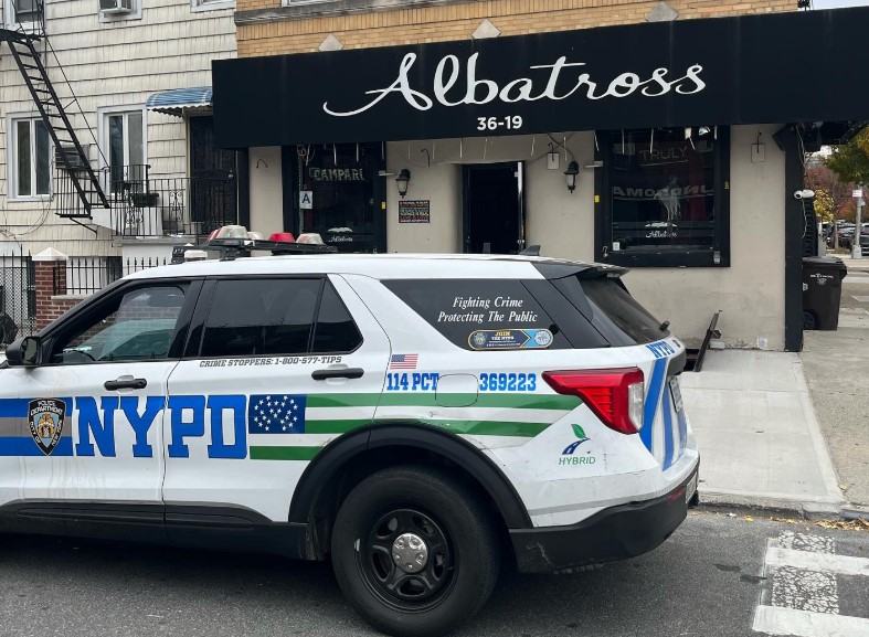 An NYPD car outside Albatross Bar on 24th Avenue on Wednesday morning. Photo: Albatross Bar Instragram