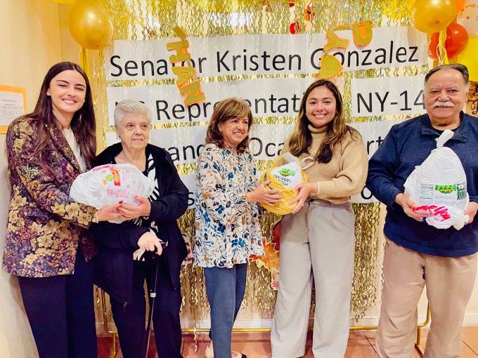 HANAC participants receive Thanksgiving turkeys, posing with Sofia Pajaj, Program Director of HANAC Harmony JVL Older Adult Center (far left), and NY State Senator Kristen Gonzalez (second from right)