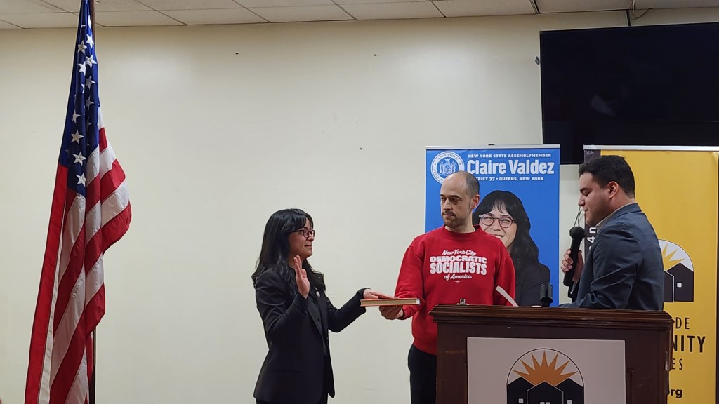 Assembly Member Claire Valdez is "sworn in" by UAW representative Brandon Mancilla. Photo: Shane O'Brien