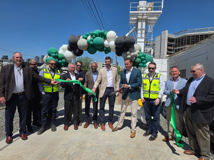 Representatives from Eco Material Technologies, New York & Atlantic Rail and Precision Terminal Logistics cut the ribbon at the new Blissville rail terminal on Tuesday. Photo: Shane O'Brien.
