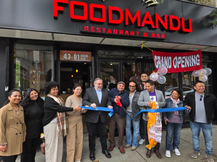 Dirk McCall de Palomá of Sunnyside Shines (center) and Foodmandhu owner Pashupati Shrestha (center, holding scissors) join community members for Foodmandhu's grand opening on Thursday. Photo: Shane O'Brien