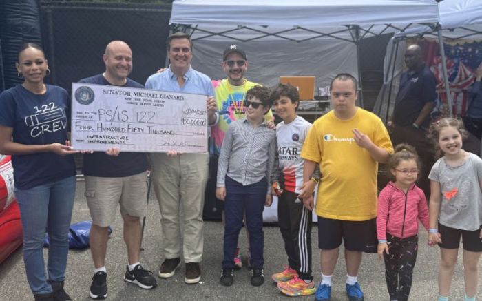 State Sen. Mike Gianaris presents PS 122 with a check for $450,000. Photo courtesy of State Sen. Mike Gianaris.