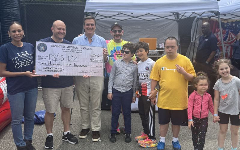 State Sen. Mike Gianaris presents PS 122 with a check for $450,000. Photo courtesy of State Sen. Mike Gianaris.